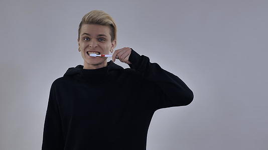 使用牙刷的年轻时尚男士视频的预览图