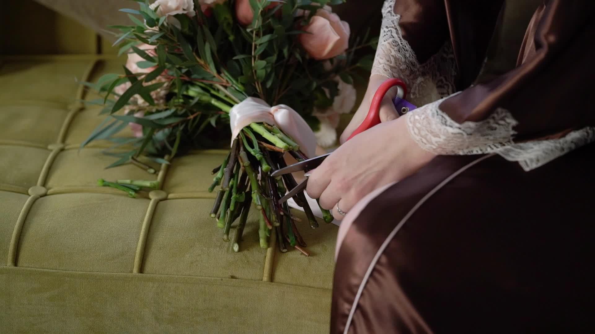 年轻女性用剪刀切玫瑰和红花视频的预览图