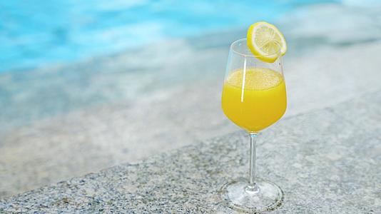 4k橙汁饮料夏季水池岸边空镜视频的预览图