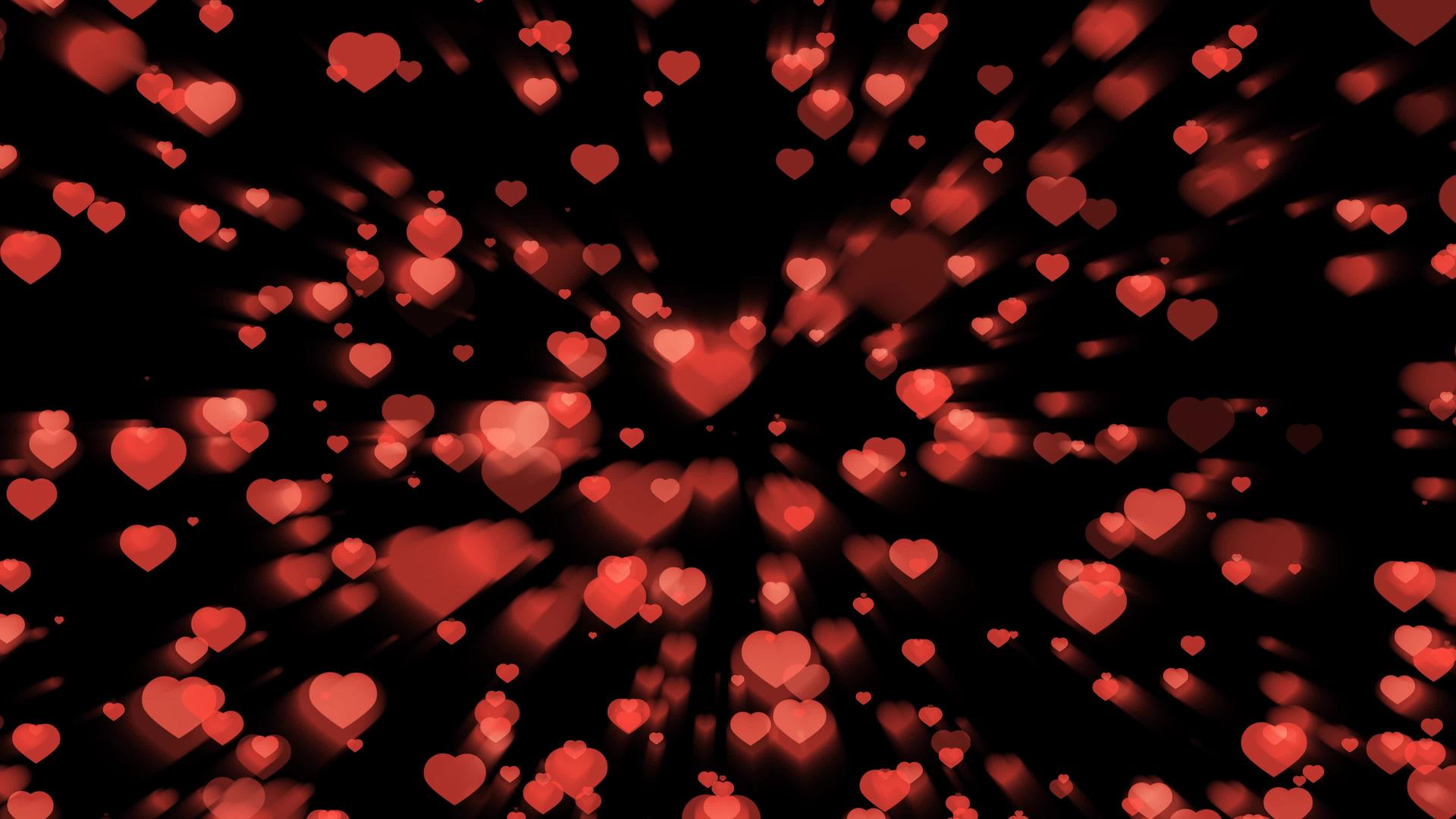 数以百万计的红心粒子和元素上下缩放在黑屏上快速闪烁视频的预览图