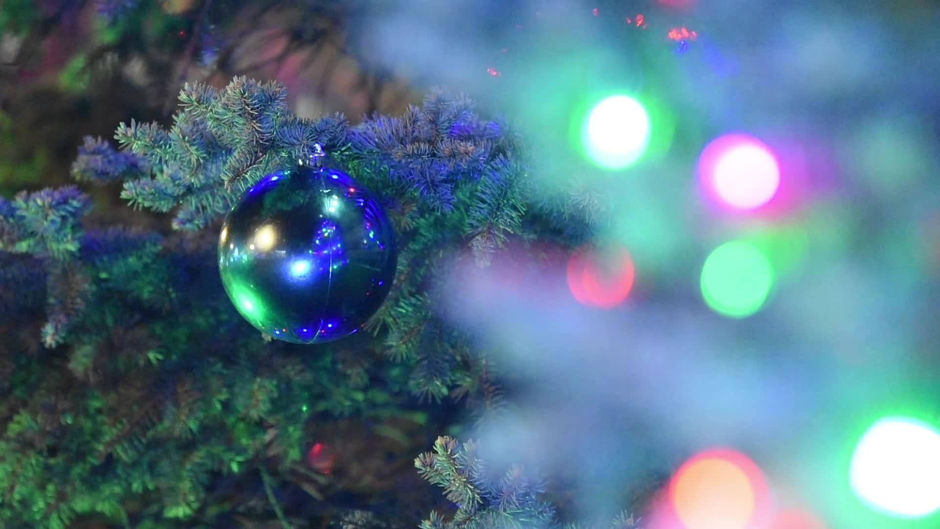 圣诞舞会挂在月亮树上在前面模糊的灯盖上视频的预览图