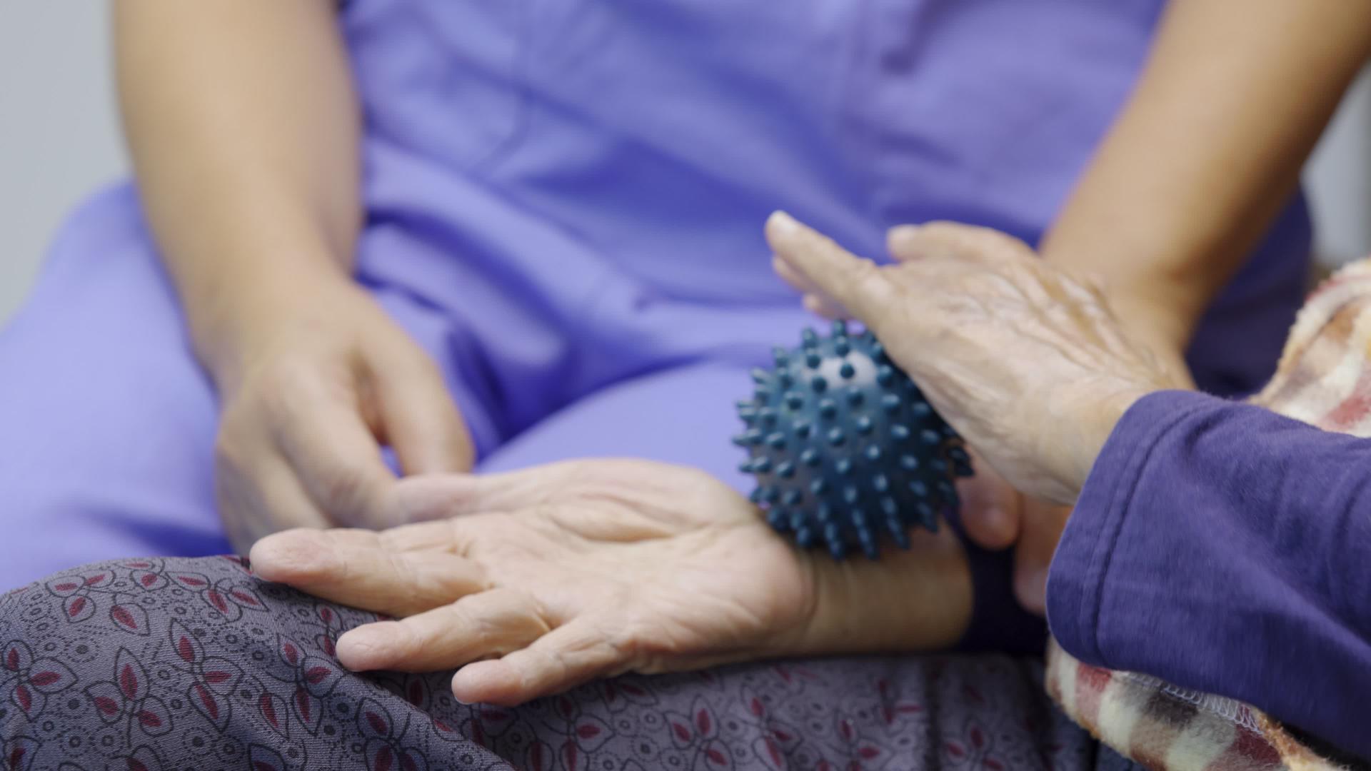 老年妇女用橡皮球锻炼手指、手掌和脚的肌肉视频的预览图