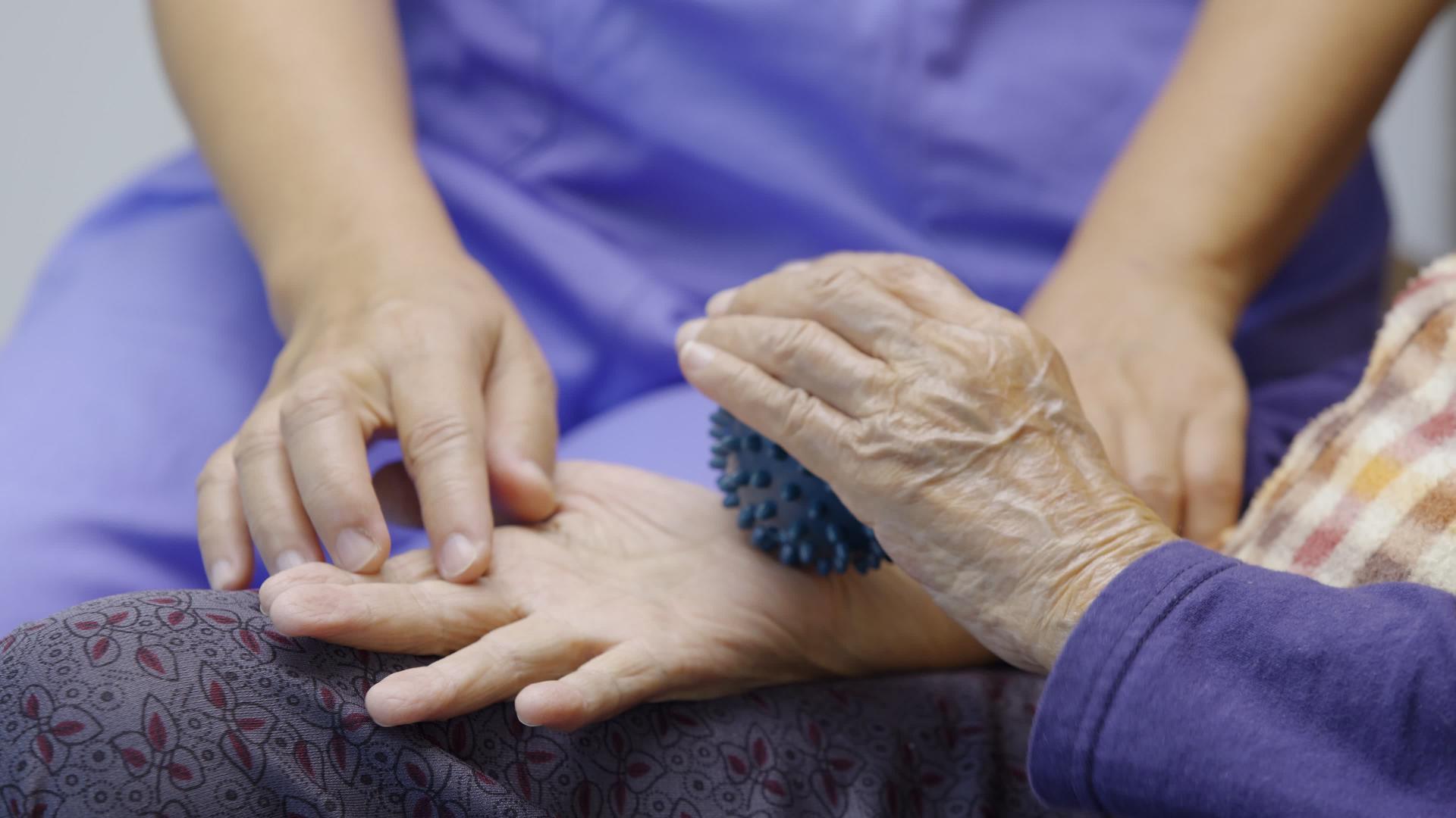 老年妇女用橡皮球锻炼手指、手掌、脚部肌肉视频的预览图