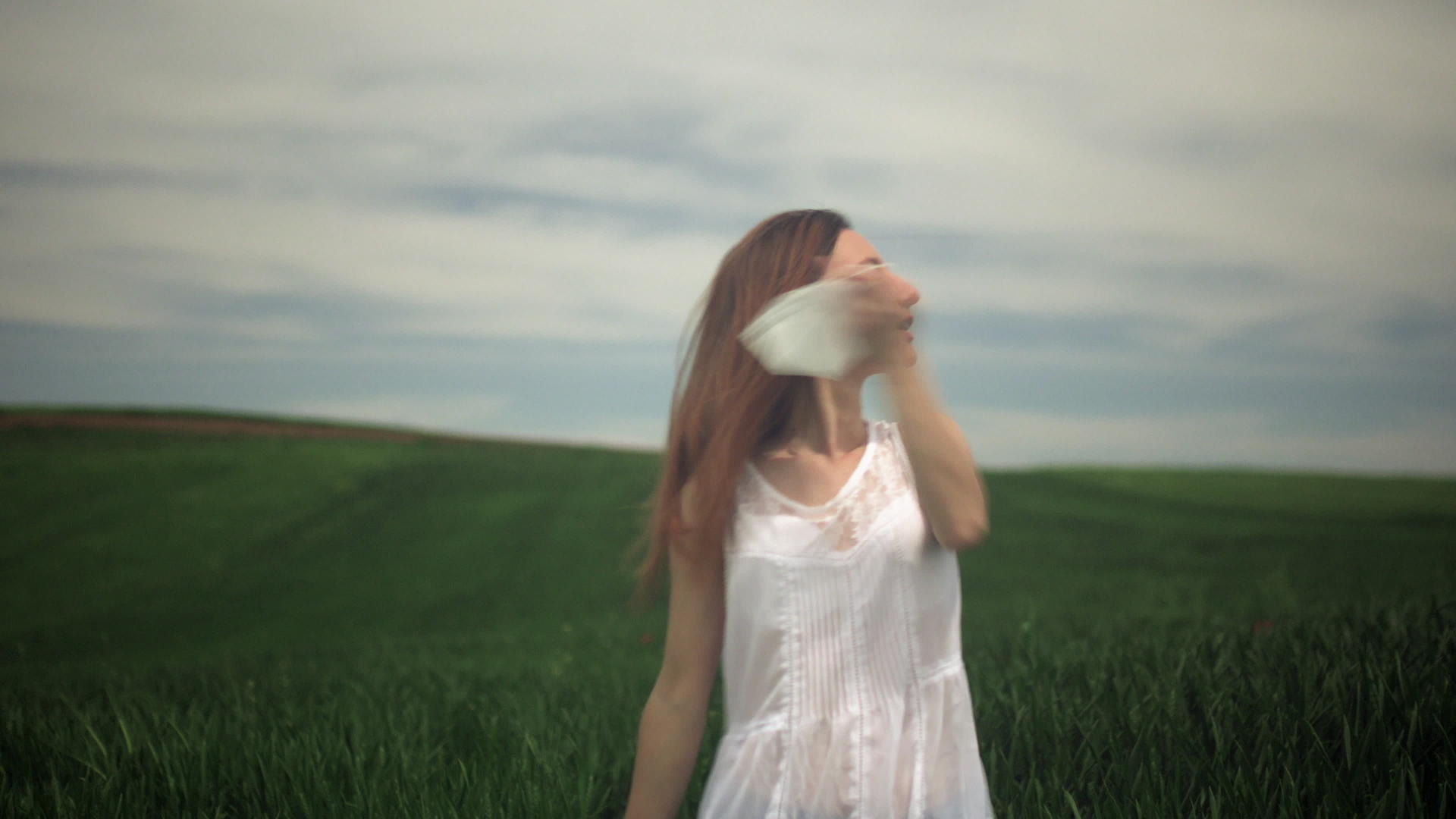 快乐的女孩摘下面具在田野里深呼吸视频的预览图