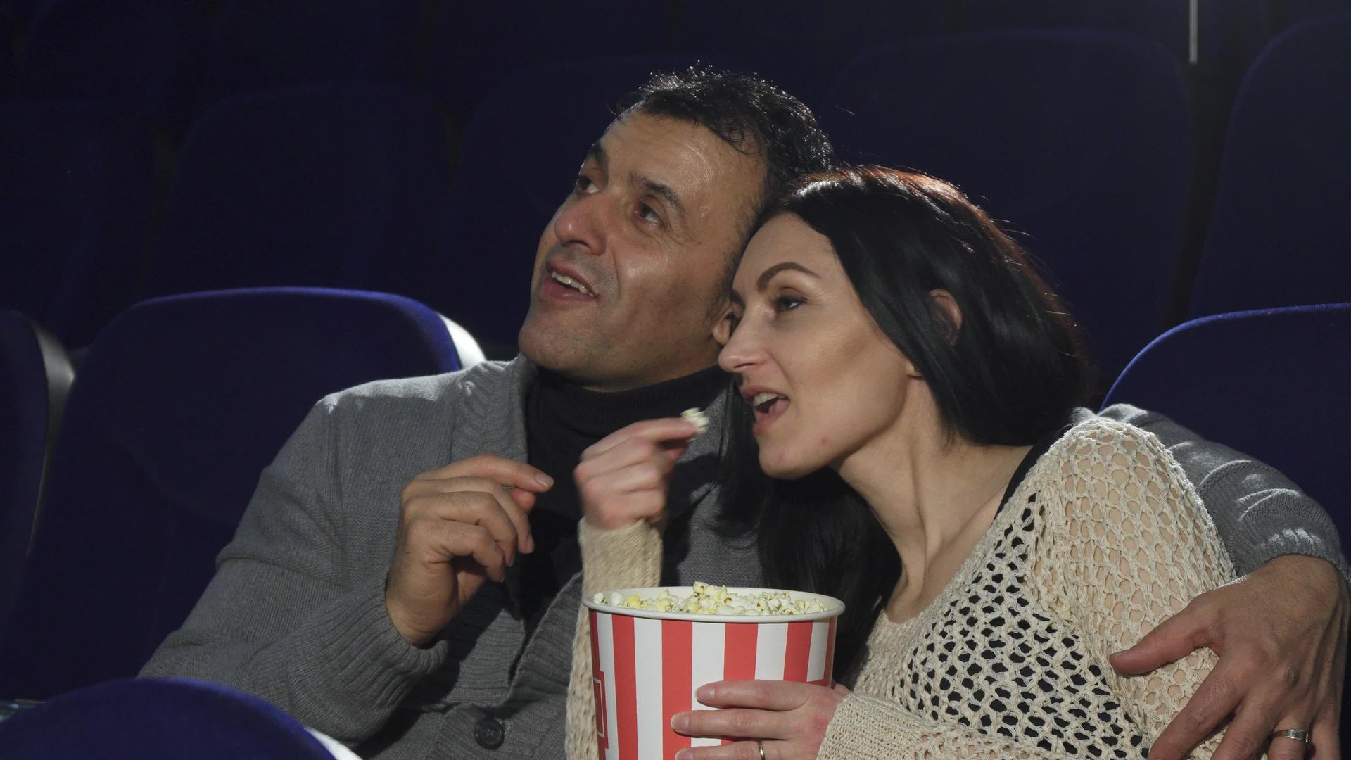 成熟快乐的情侣在电影院看电影时享受约会视频的预览图