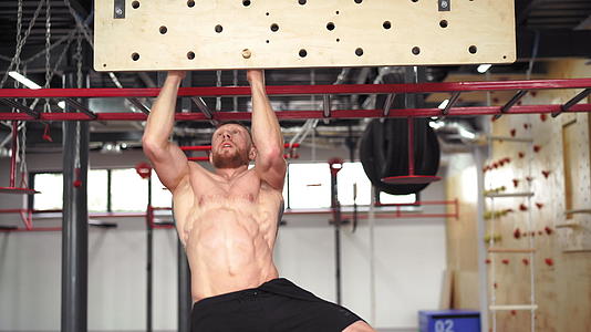 男子攀登钉板健身房运动员在室内训练手臂力量和耐力视频的预览图