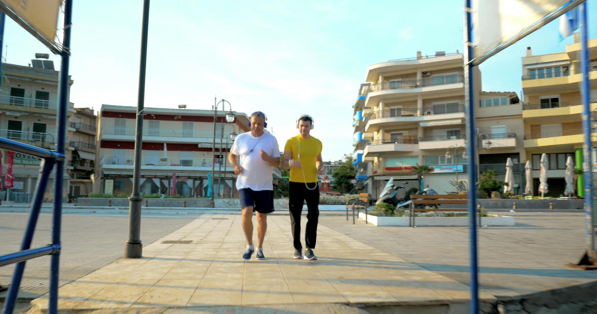 父亲和儿子在度假城市用耳机慢跑视频的预览图