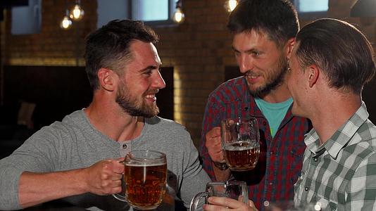 一群朋友对着镜头微笑在酒吧里举起啤酒杯视频的预览图