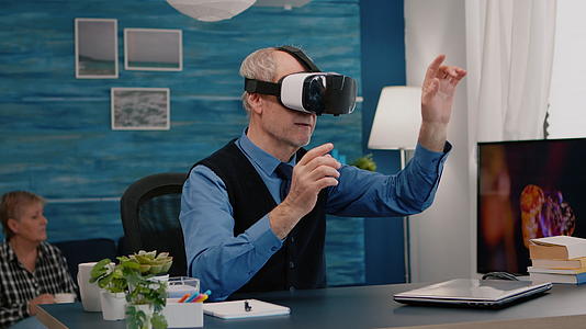 在客厅使用退休男子Vr体验虚拟现实的耳机视频的预览图