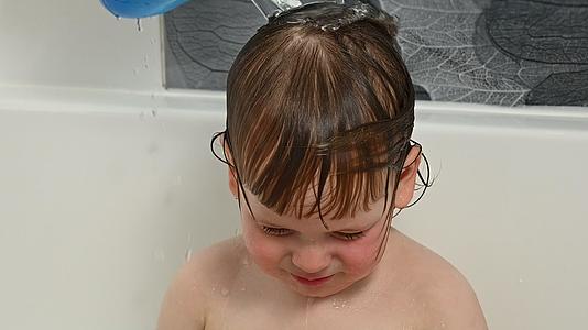 小男孩在淋浴水里洗头视频的预览图