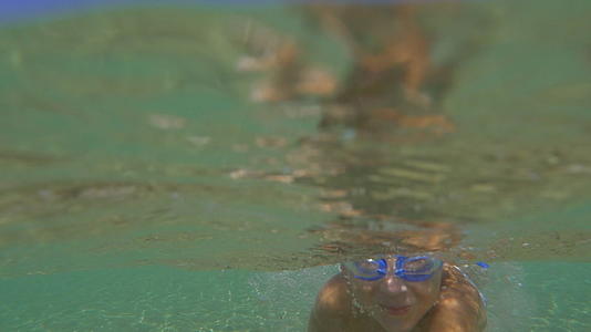 护目镜男孩在海洋水下游泳视频的预览图