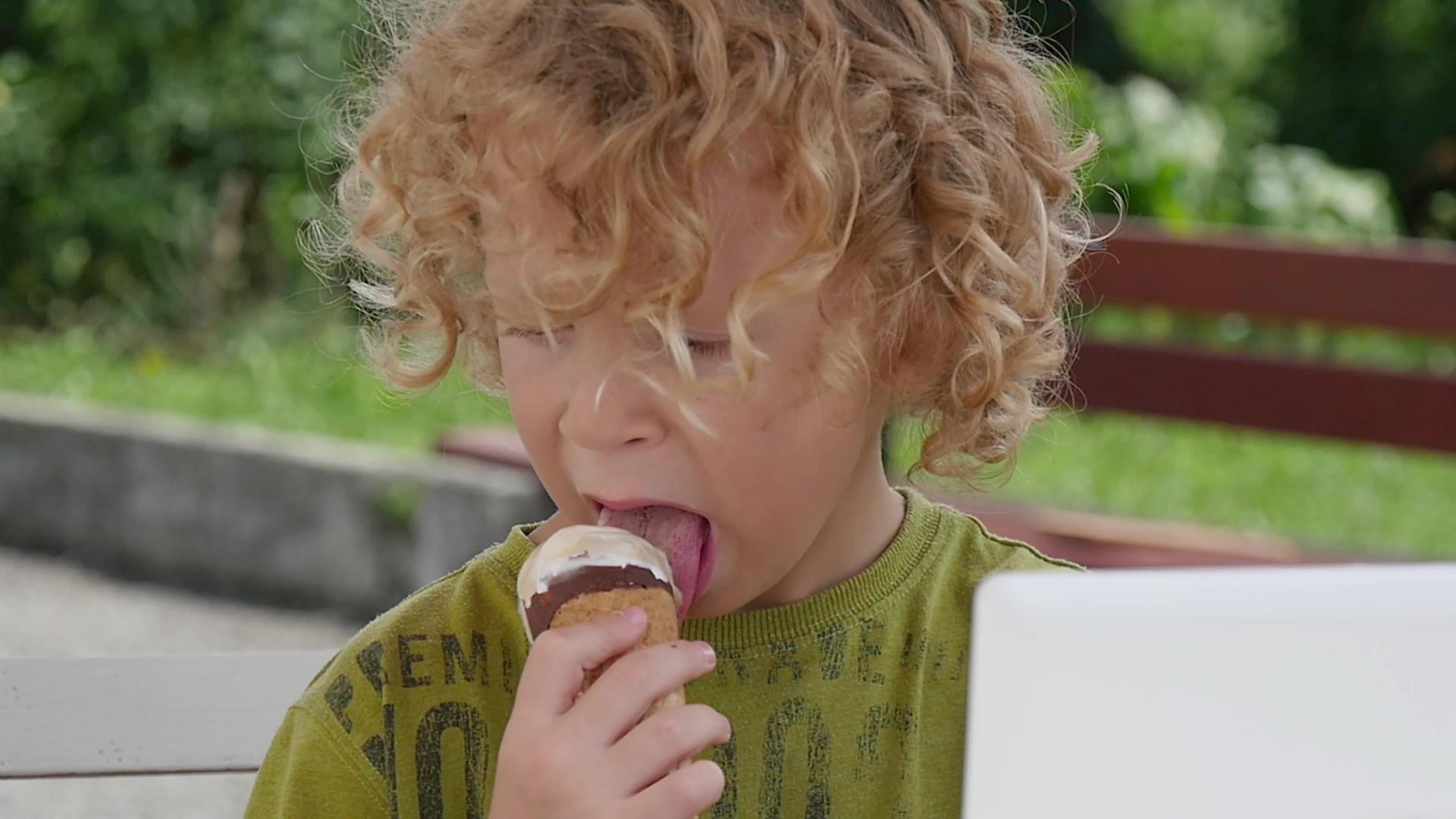 吃冰淇淋的金发小男孩视频的预览图