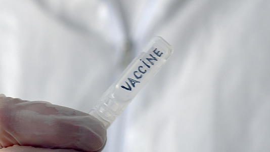 在科学实验室的白色背景下学者们用疫苗管关闭了生物视频的预览图