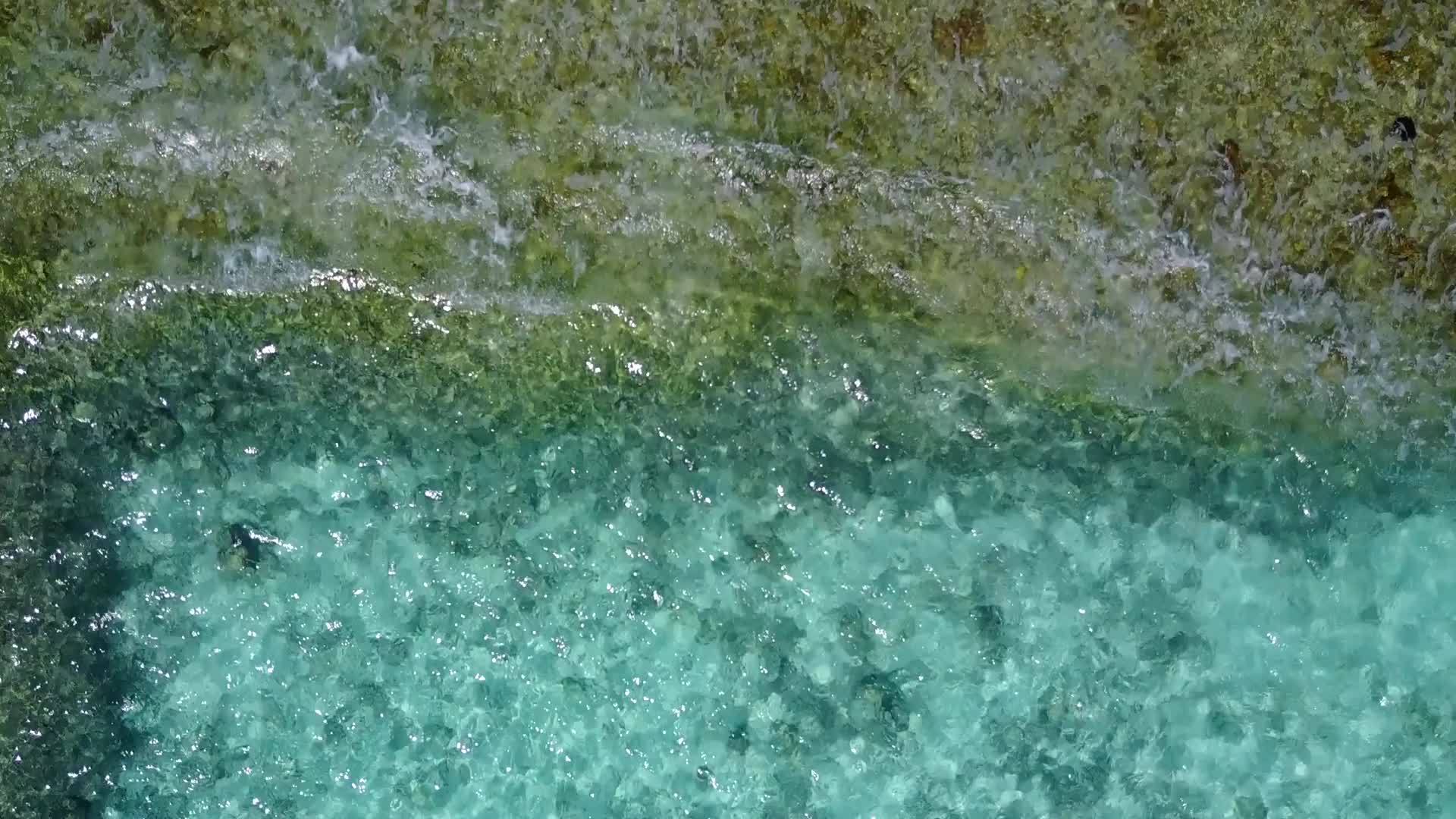 以蓝水和海滩附近的白沙土为背景观察蓝水的海滨时间视频的预览图