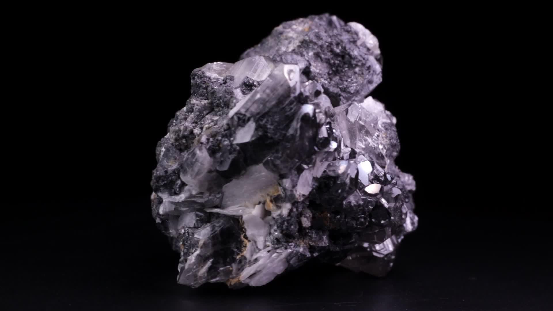 闪亮的岩石有银石晶体在黑色背景上缓慢旋转也被称为铅视频的预览图