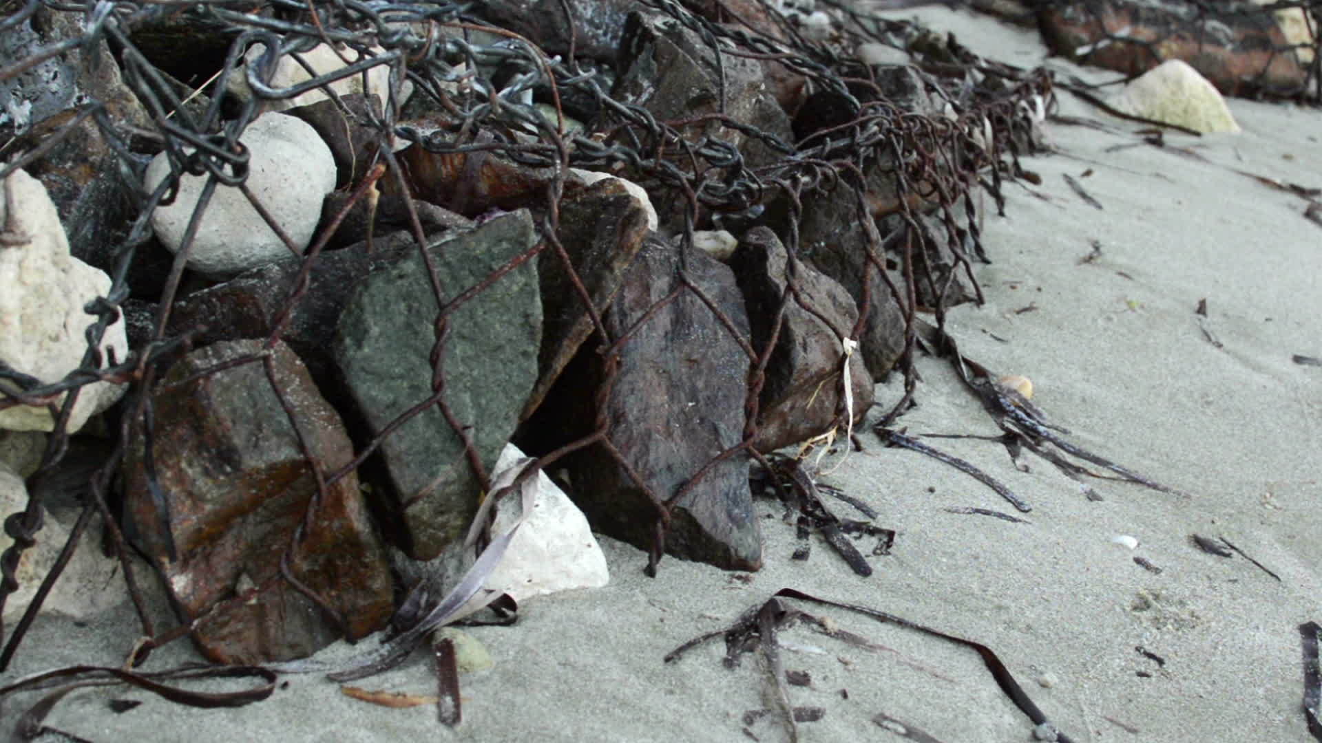 石头被铁丝钉在海岸上视频的预览图