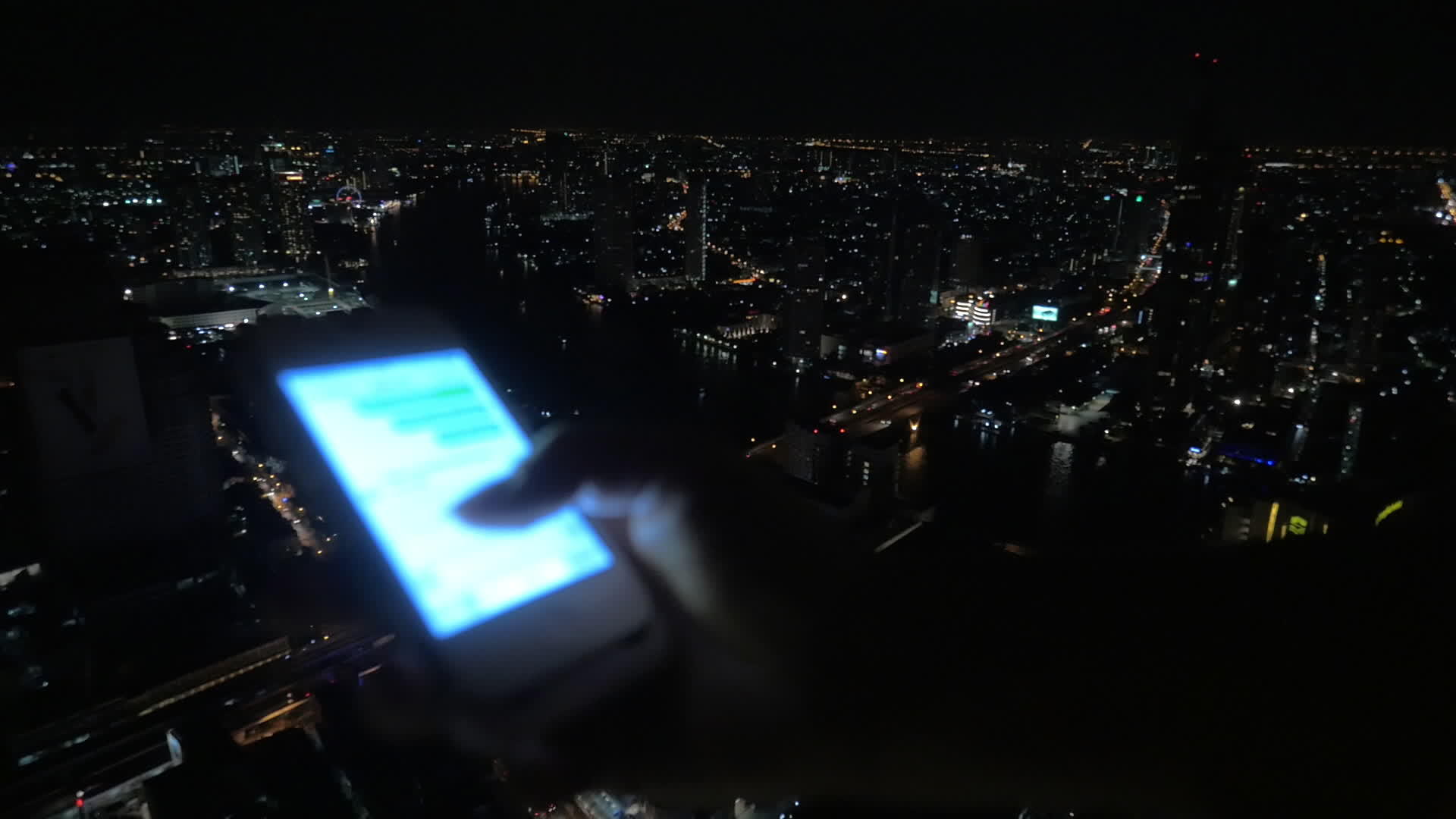 女孩在夜间城市背景的手机上发短信视频的预览图