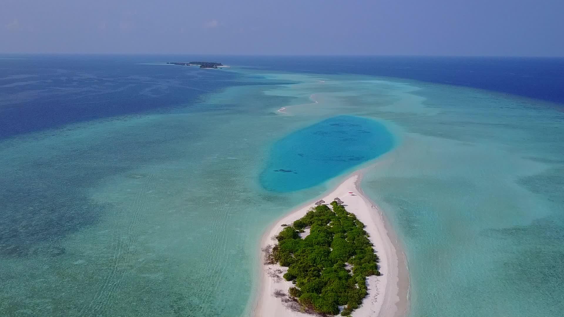 环礁湖周围的豪华海滩时间是由空中无人驾驶的绿色海洋和白沙背景形成的视频的预览图