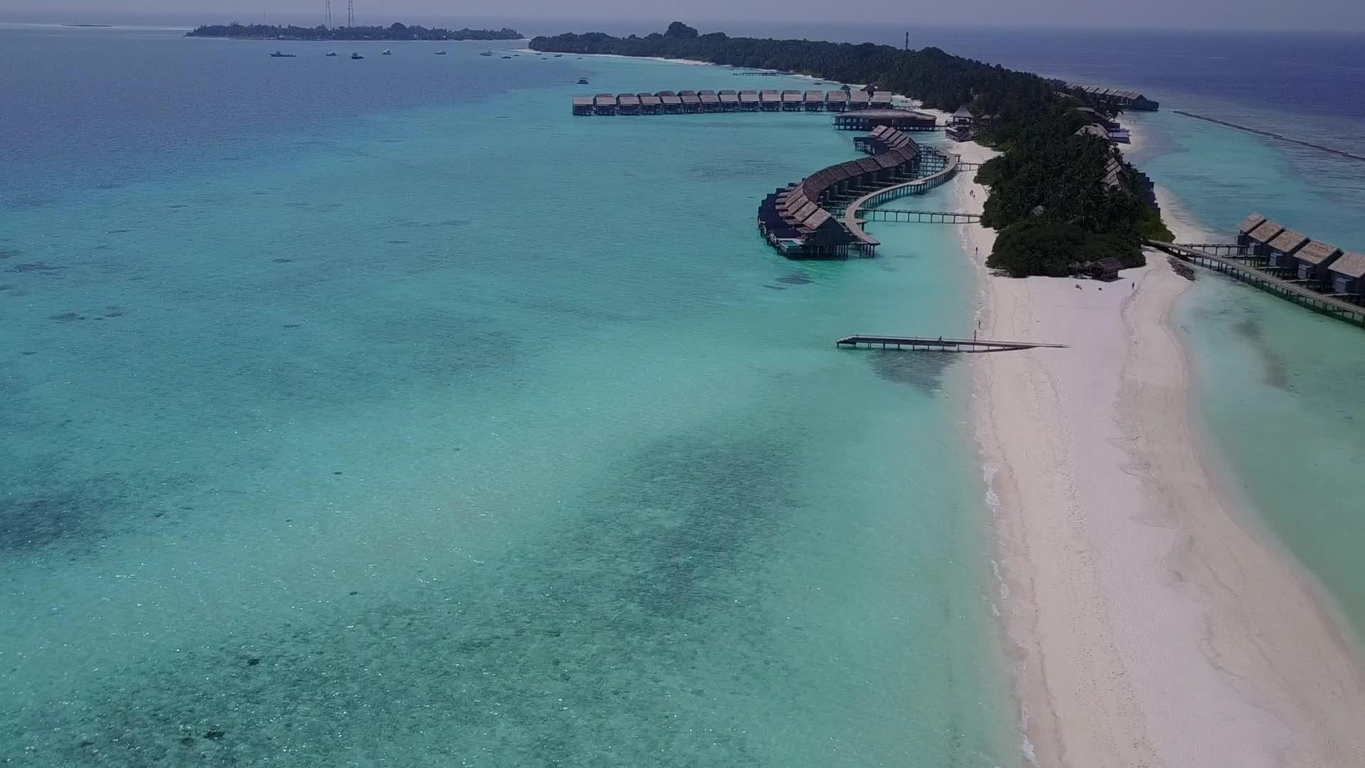 天堂湾海滩的空中无人驾驶通过透明的海面和白色的海滩背景打破视频的预览图