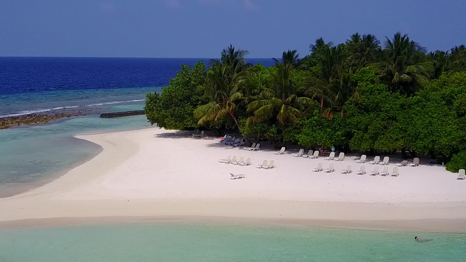 宁静的海岸线以海蓝水和白沙为背景在海岸海滩的风中在空中视频的预览图