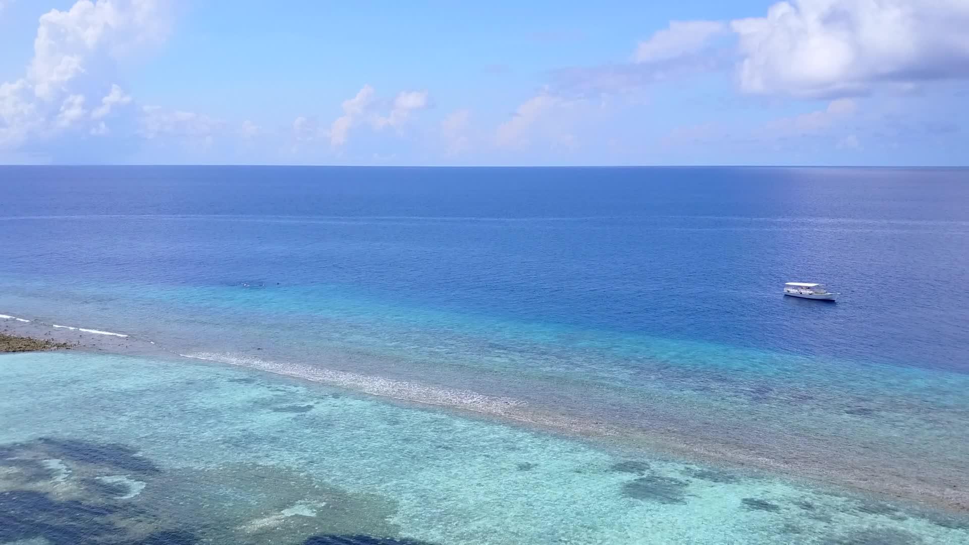 在蓝色的水和白色的沙子的背景下在美丽的海滩上航行的无人机景观的全景视频的预览图