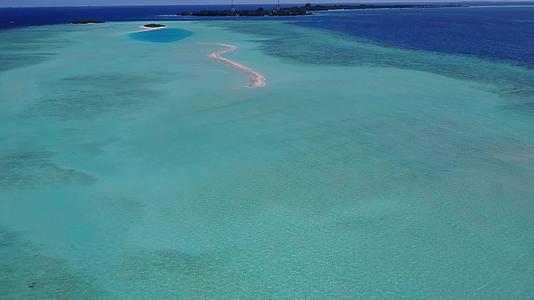 沿海海滩以浅沙为背景以绿色松湖环礁为背景的金色蓝岩层视频的预览图