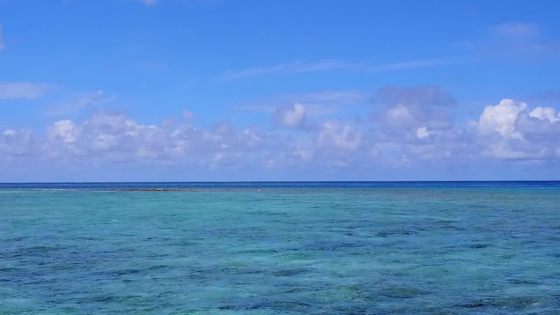 蓝色泻湖和白色海滩背景下的海洋度假村海滩度假村视频的预览图