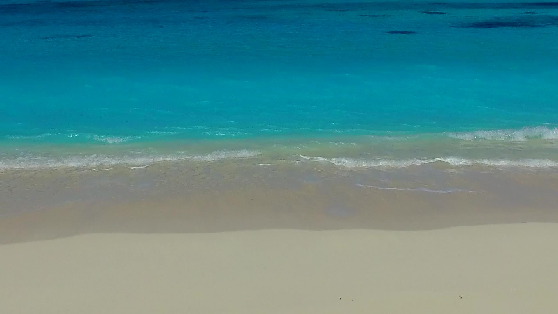 由于冲浪附近清晰的环礁湖和白色海滩背景热带环礁湖海滩视频的预览图