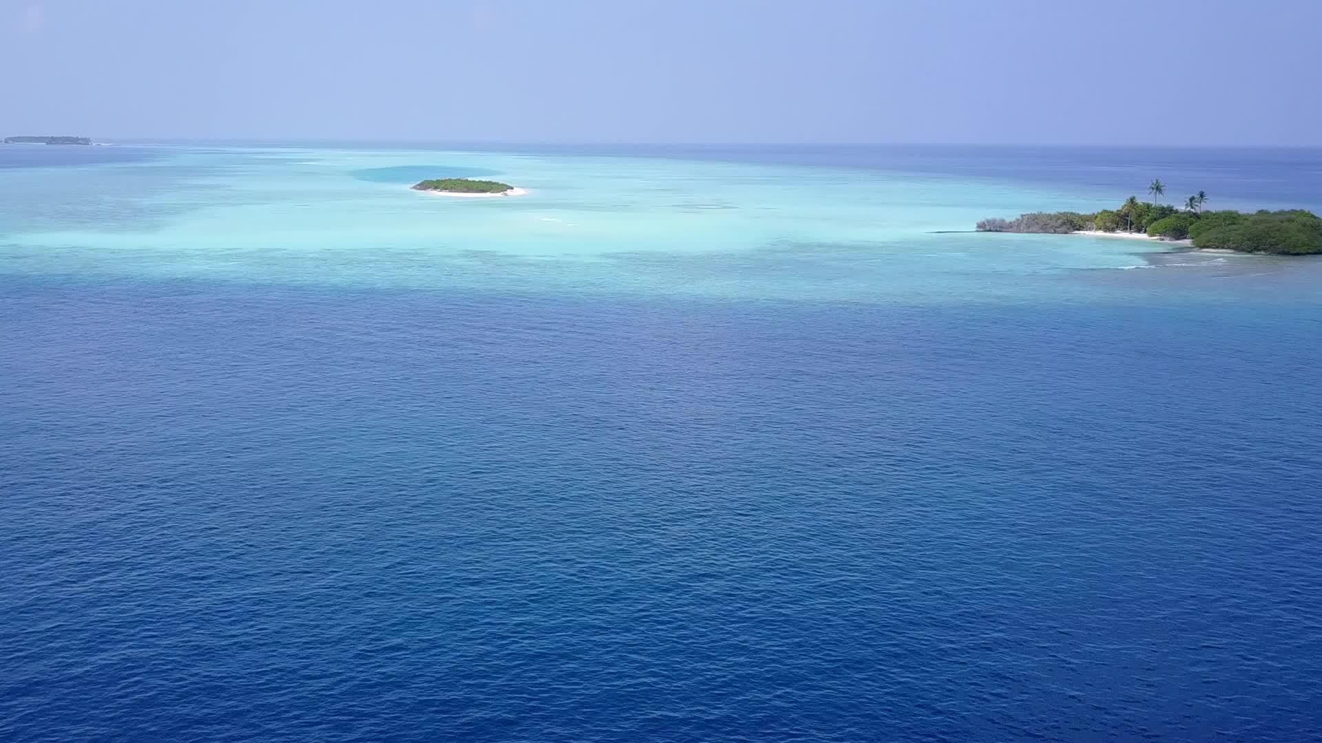在一个安静的海滩度假日里珊瑚礁附近有蓝色的白色沙子背景视频的预览图