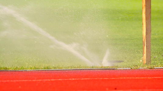足球或足球场灌溉系统自动浇灌足球场外的体育场视频的预览图
