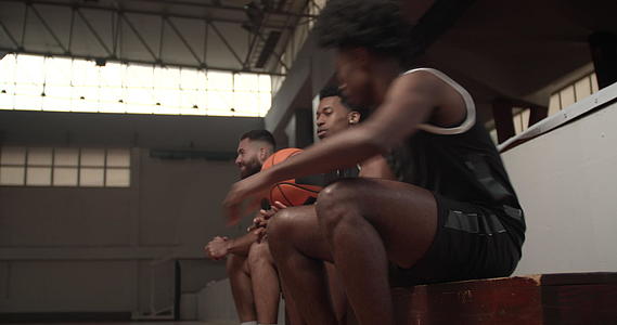 篮球运动员坐在长凳上与队友一起参加比赛视频的预览图