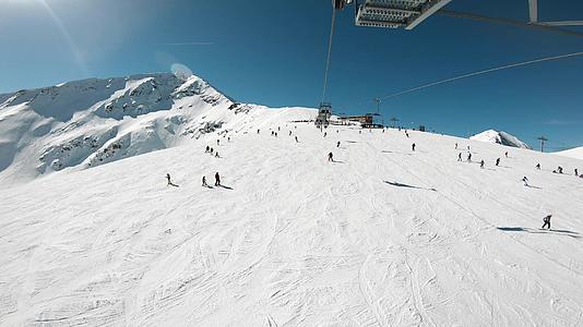 从滑雪的第一个角度我们可以看到滑雪者的斜坡和远处的雪山视频的预览图