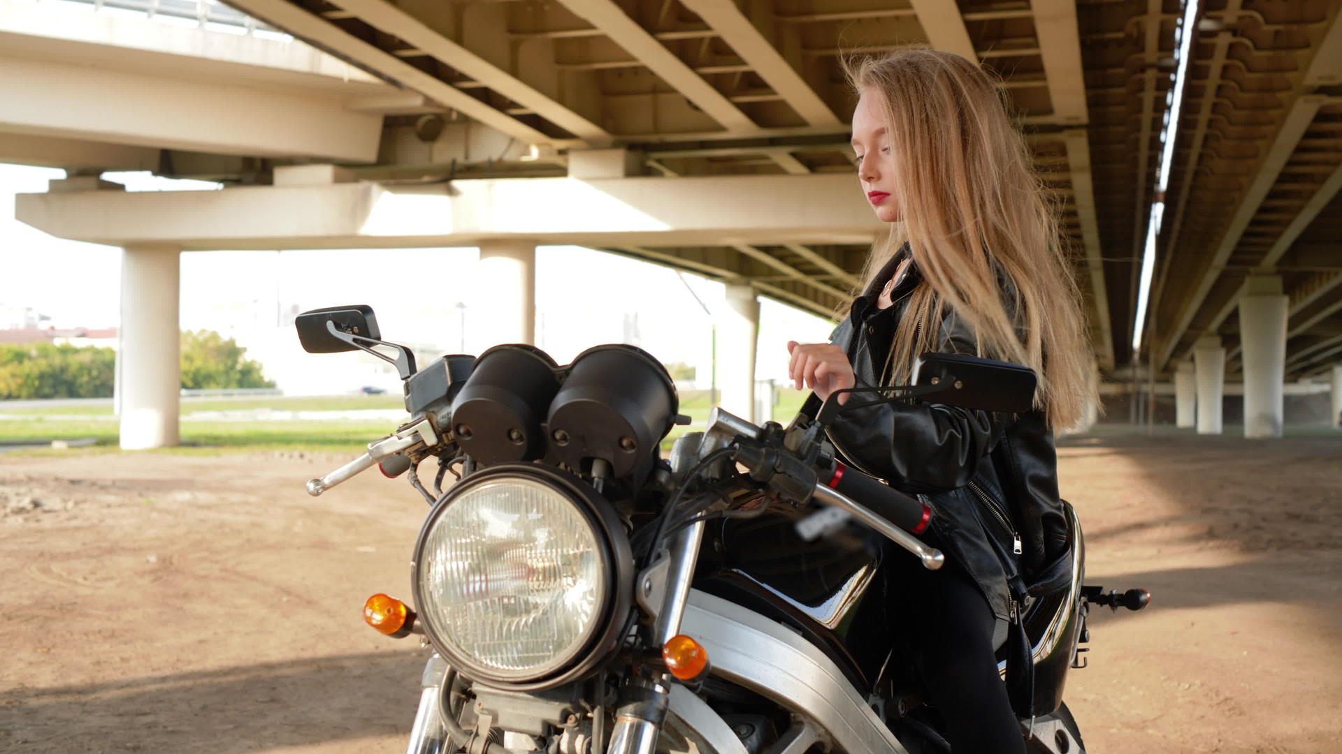 黑色摩托车皮夹克的女孩骑摩托车的女孩靠近美丽的美丽视频的预览图