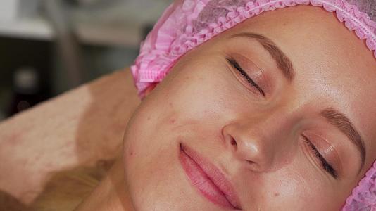 在美容沙龙接受面部治疗的年轻女性视频的预览图