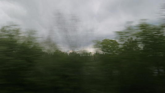 从火车窗口可以看到阴阳边的风景树林房屋和云层视频的预览图