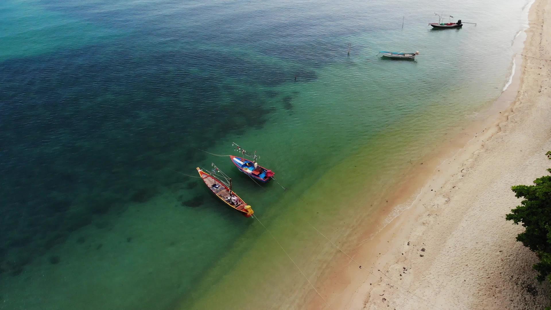 渔船漂浮在雄伟的珊瑚礁附近的蓝色的蓝色视频的预览图