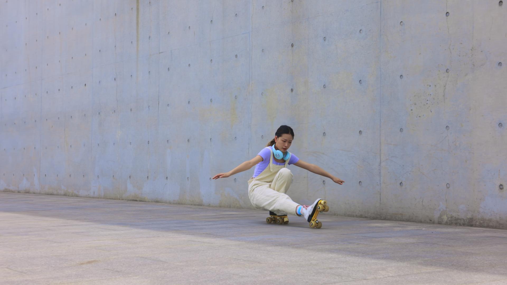 年轻女孩在空地上练习轮滑视频的预览图