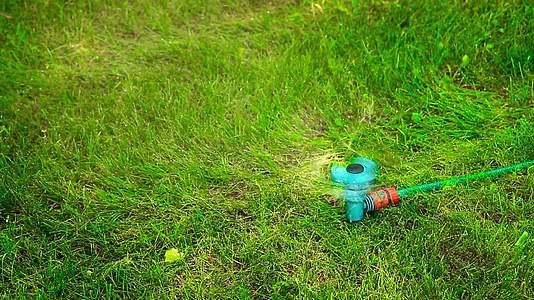 在炎热的夏天在草坪上移动水喷雾器Hd1080视频的预览图