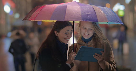 女朋友在城市雨夜使用触摸垫视频的预览图