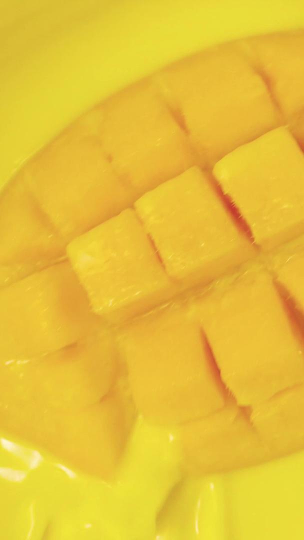 金黄色芒果落入果汁水中视频的预览图