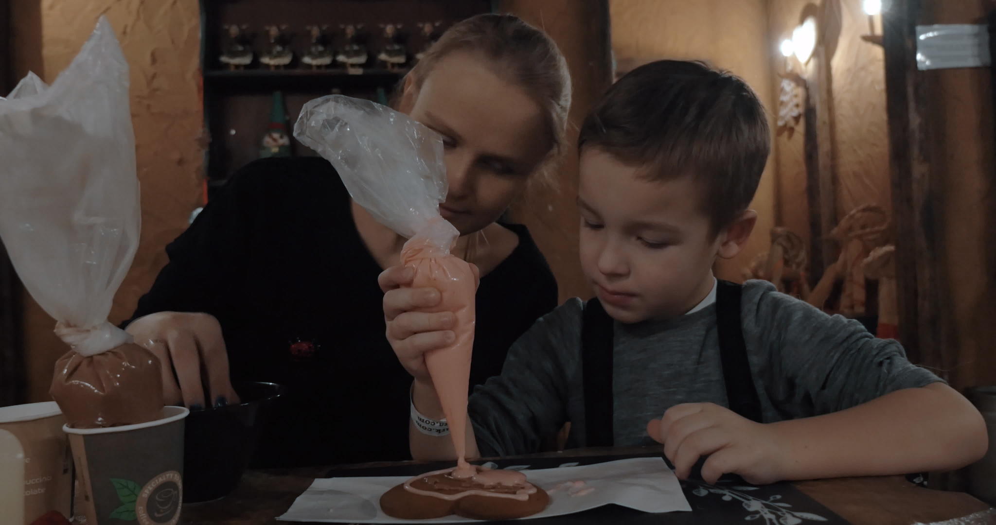 婴儿和母亲用冰淇淋装饰饼干视频的预览图