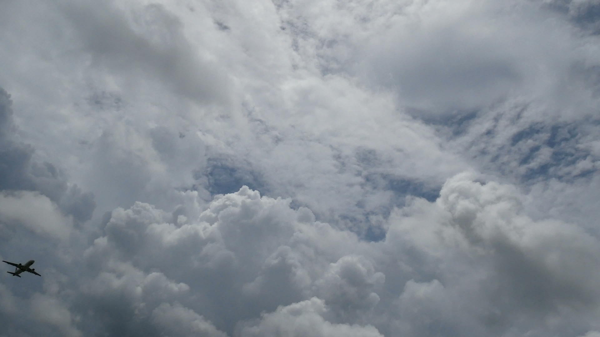 飞机飞过多云的天空视频的预览图