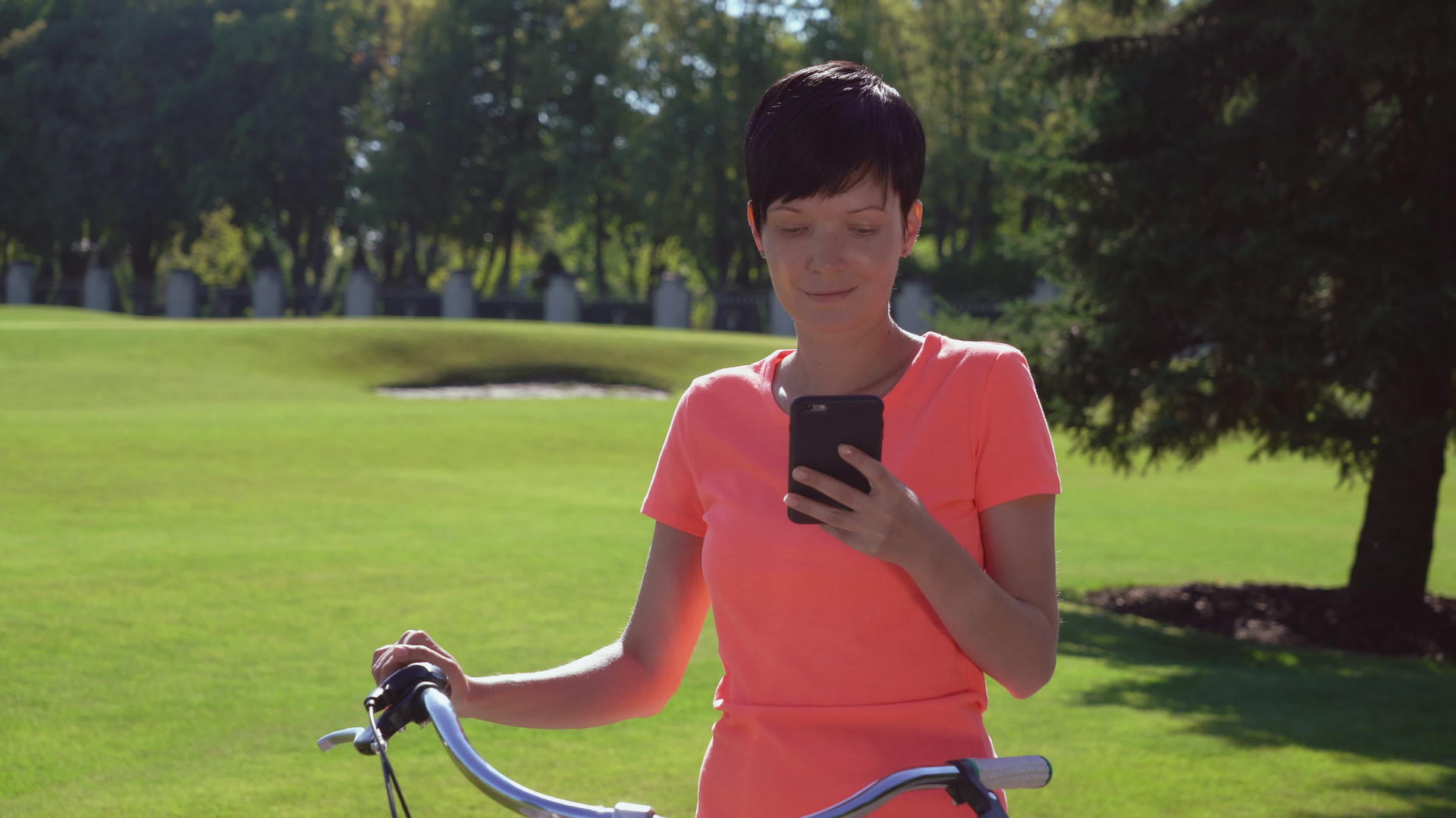 坐在自行车上看手机的女人视频的预览图
