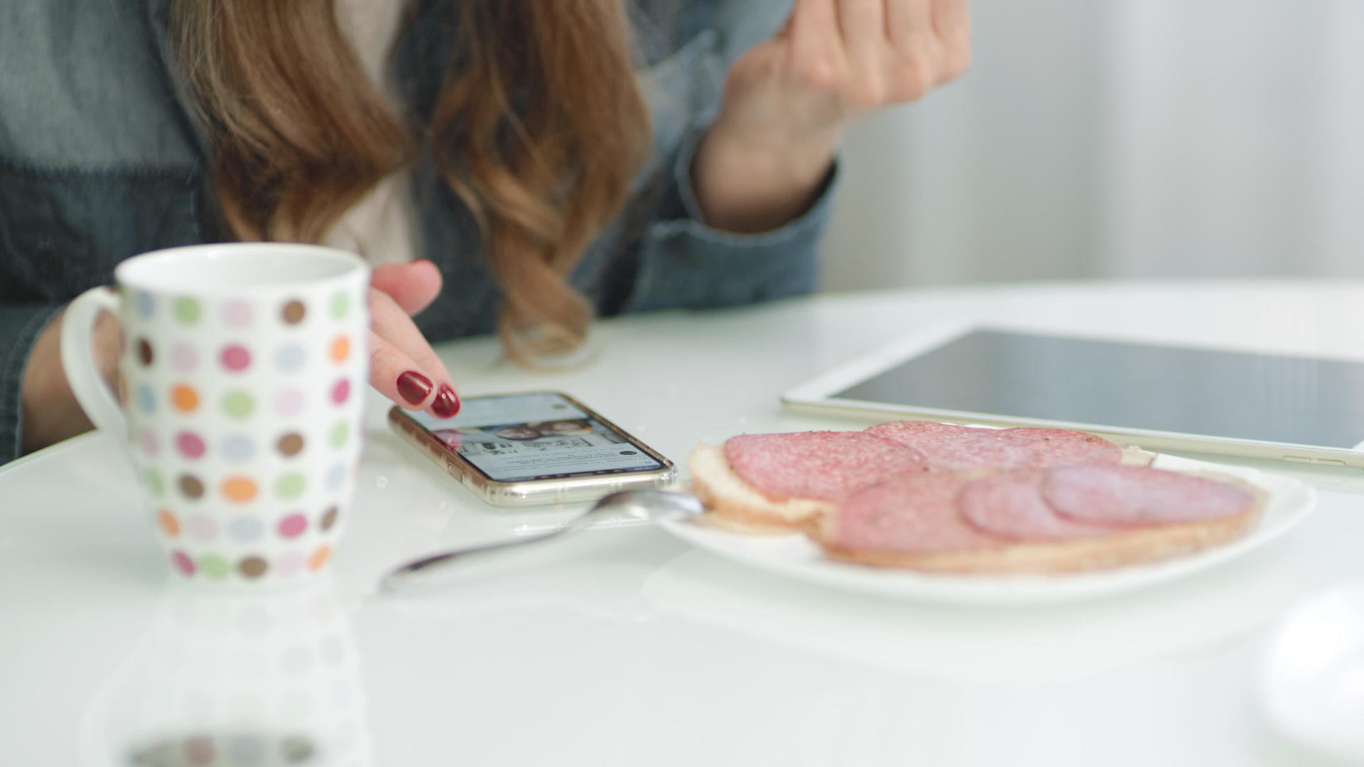 在厨房早餐时使用智能手机视频的预览图