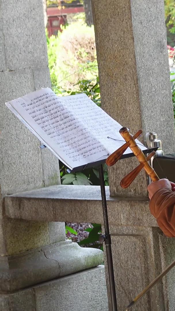 研究中国传统文化民乐器乐二胡的城市公园退休老人素材视频的预览图