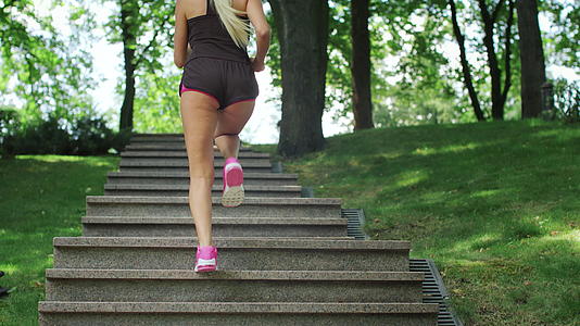 健身女性在夏季公园晨跑时上楼梯视频的预览图