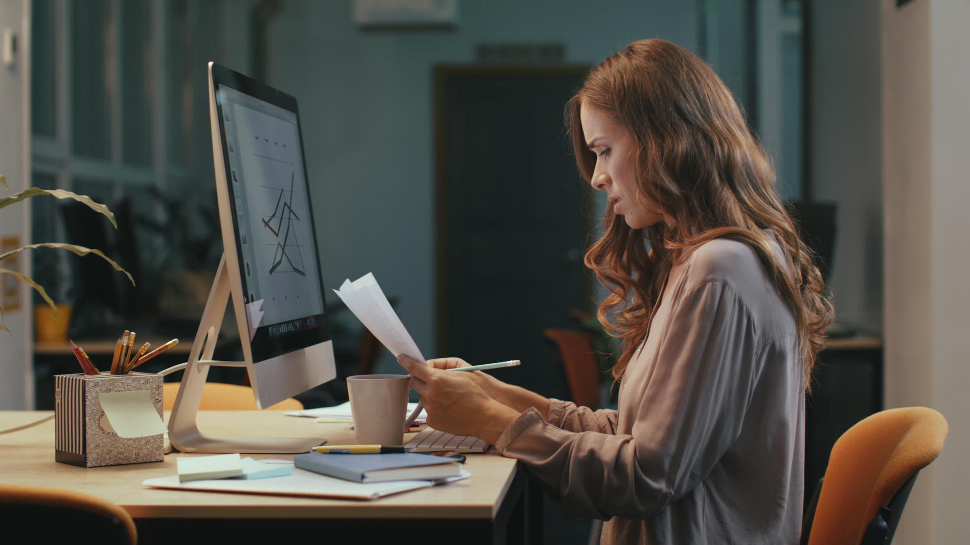重点商业女性在夜间办公室处理文件视频的预览图