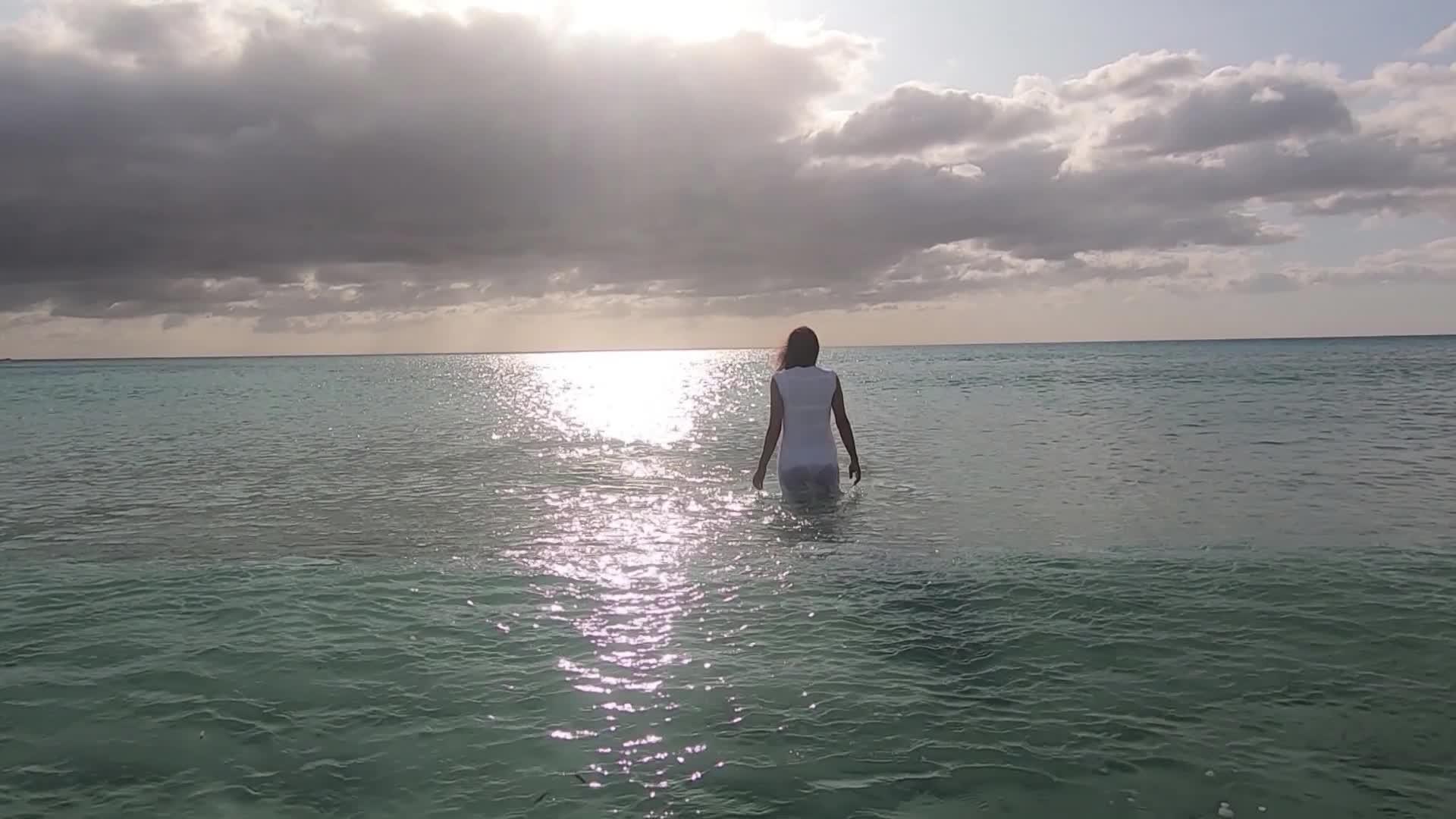 黎明时在海水中的女性背影视频的预览图