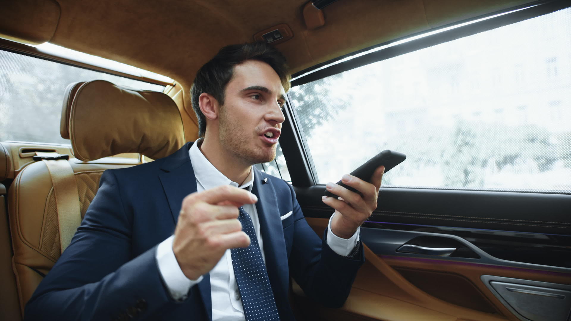 在现代车厢中商业男士使用智能手机回复消息视频的预览图
