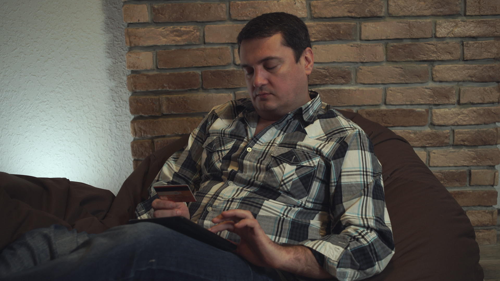 一名坐在椅子上的男子用平板电脑付款视频的预览图